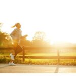 Healthy Woman Running On A Road