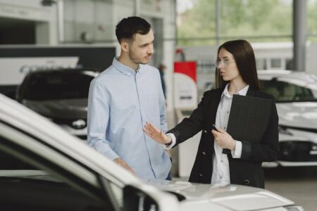 https://www.pexels.com/photo/woman-selling-car-to-client-in-salon-4895420/