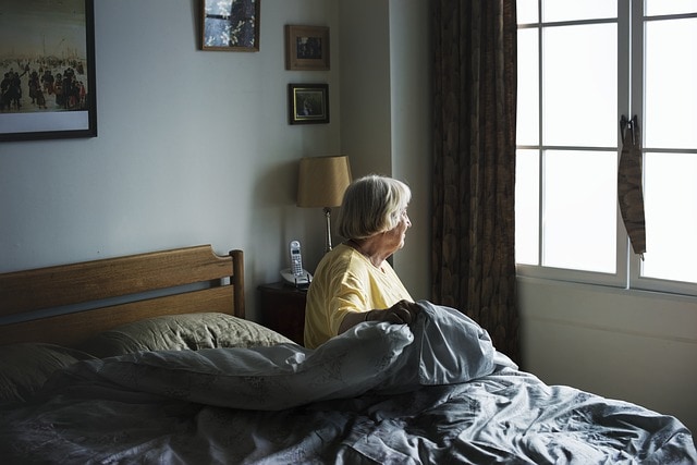 Senior Women in bed At Senior Living Home Care