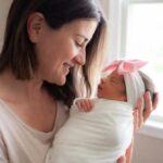 A Mother and a newborn baby girl - Top Recommended Nasal Aspirators for Parents #NasalAspirator, #BabyNoseSucker, #NoseFrida, #NozeBot, #BabyCongestion, #ElectricNasalAspirator, #Momcozy, #Grownsy, #BabyHealth2025, #ParentingEssentials