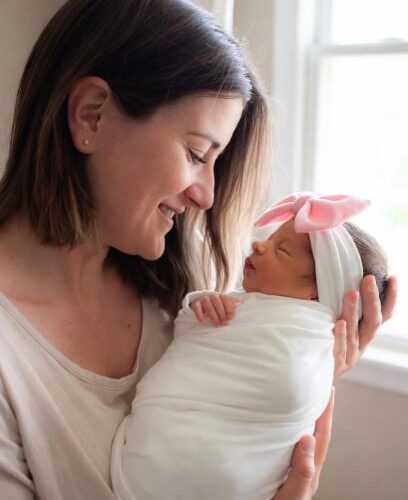 A Mother and a newborn baby girl - Top Recommended Nasal Aspirators for Parents #NasalAspirator, #BabyNoseSucker, #NoseFrida, #NozeBot, #BabyCongestion, #ElectricNasalAspirator, #Momcozy, #Grownsy, #BabyHealth2025, #ParentingEssentials