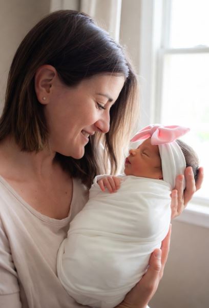 A Mother and a newborn baby girl - Top Recommended Nasal Aspirators for Parents #NasalAspirator, #BabyNoseSucker, #NoseFrida, #NozeBot, #BabyCongestion, #ElectricNasalAspirator, #Momcozy, #Grownsy, #BabyHealth2025, #ParentingEssentials